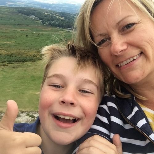 Mother and son giving a big thumbs up on Haytor Dartmoor