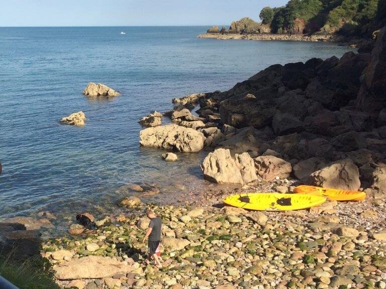 Kayaks ashore on a secluded Devon cove