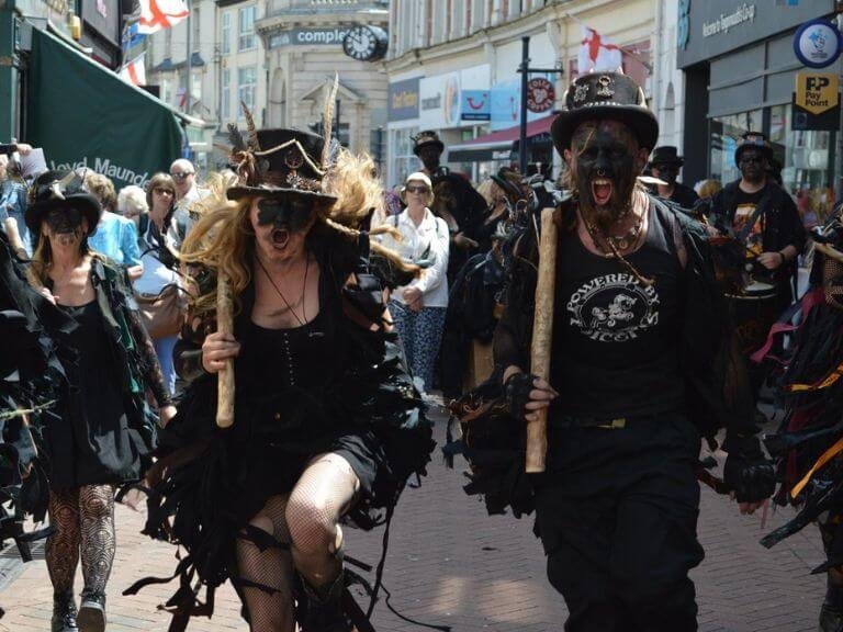 two_blackened_morris_dancers_charging_forward_screaming