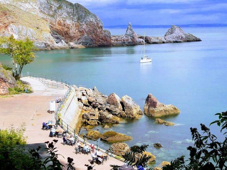 Solitary yacht in tranquil cove with a small promenade