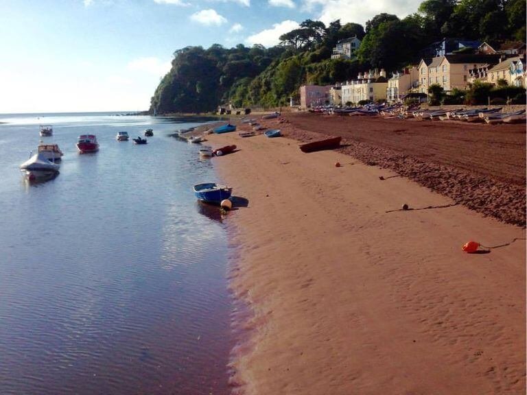 Deserted sandy beach with a multitude of sailing dinghy's