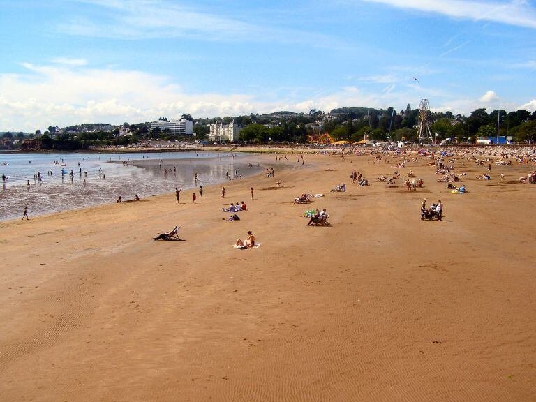 Long Sandy beach with hotels and fun fair in the background