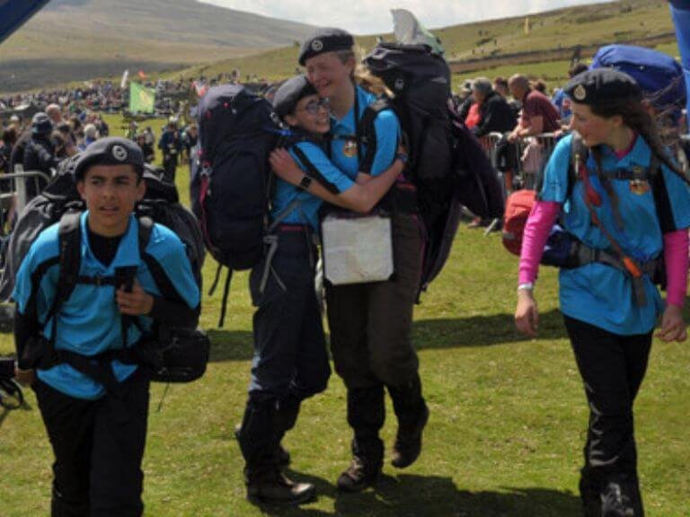 Emotional young cadet team crossing the finish line of the 10 tors challenge