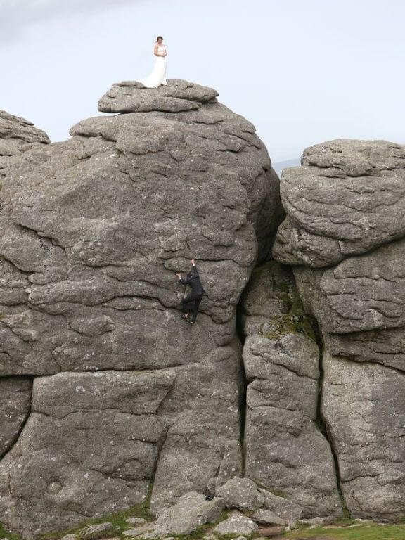 Groom_climbing_up_Haytor_to_reach_bride_at_top